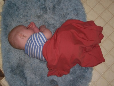 [Anderw sleeping on a rug]