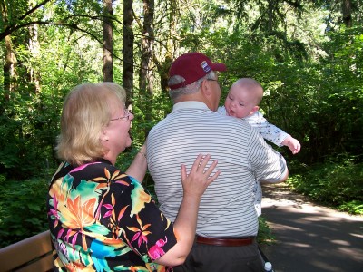 [Grandma Toni and Grandpa
Dale carrying Andrew in the forest]