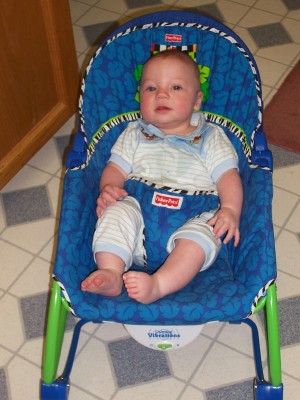 [Owen sitting in the bouncy chair]